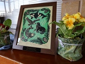 2025 Earth Day Award Art by Melissa Pothier, framed art of salmon, sea otter, whale and eagle