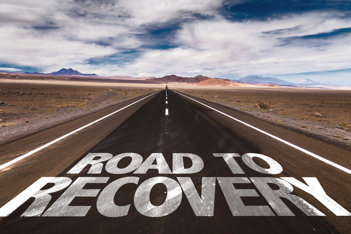 road in desert with text "road to recovery"